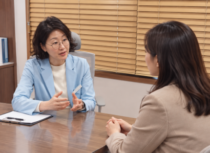 진료실에서 원장이 자궁내막증 환자와 마주 앉아 상담하는 모습