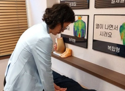 만성 요추 염좌 상담, 허리 양쪽 굳은 정도를 손으로 확인하는 장면